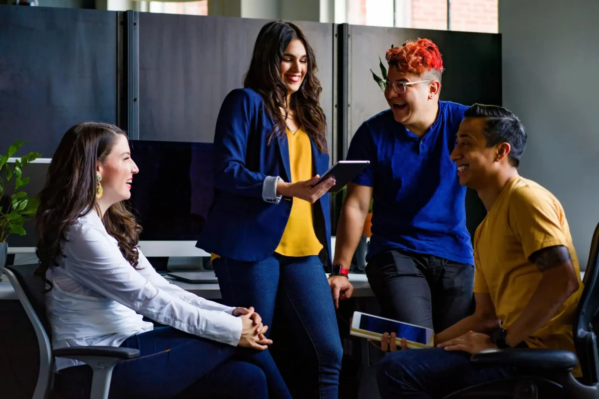 Four people talking in an office.