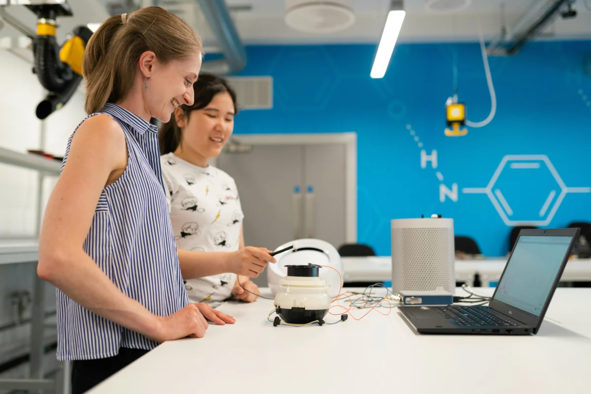 Two female engineers testing a product in a workshop.