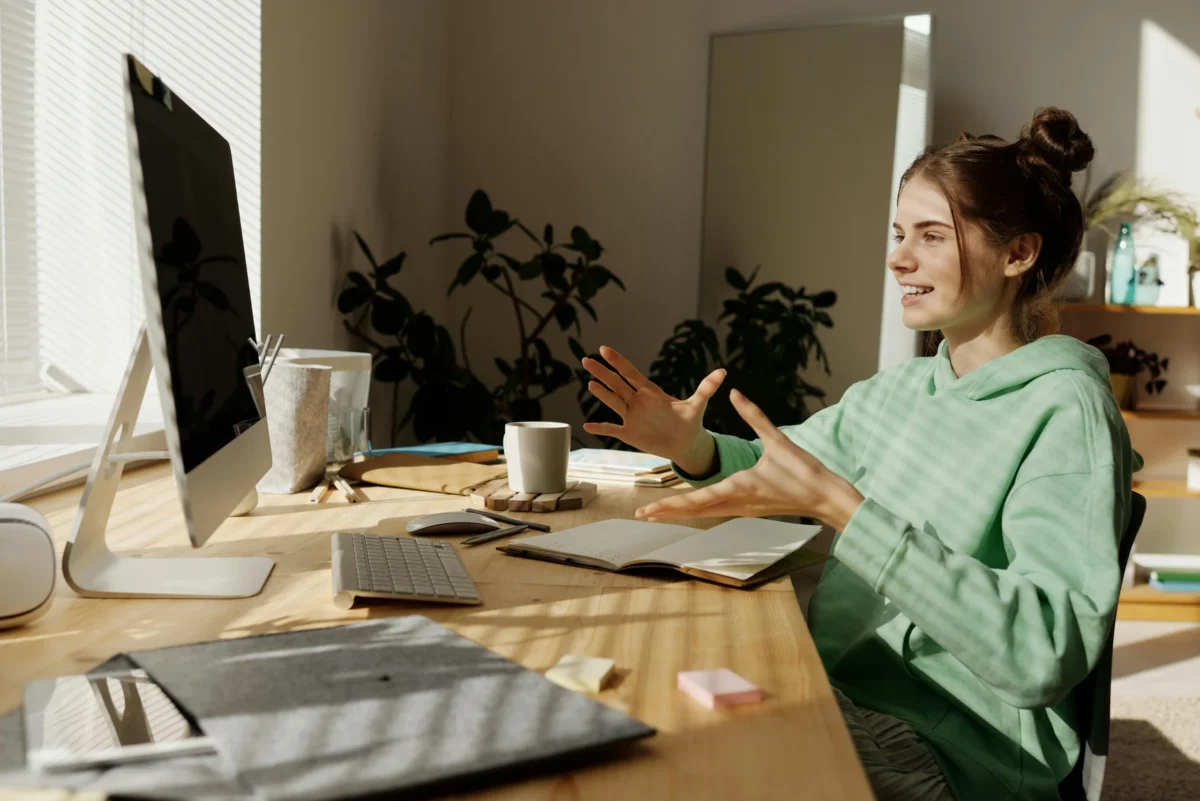 A woman chats on a video call from her home office.