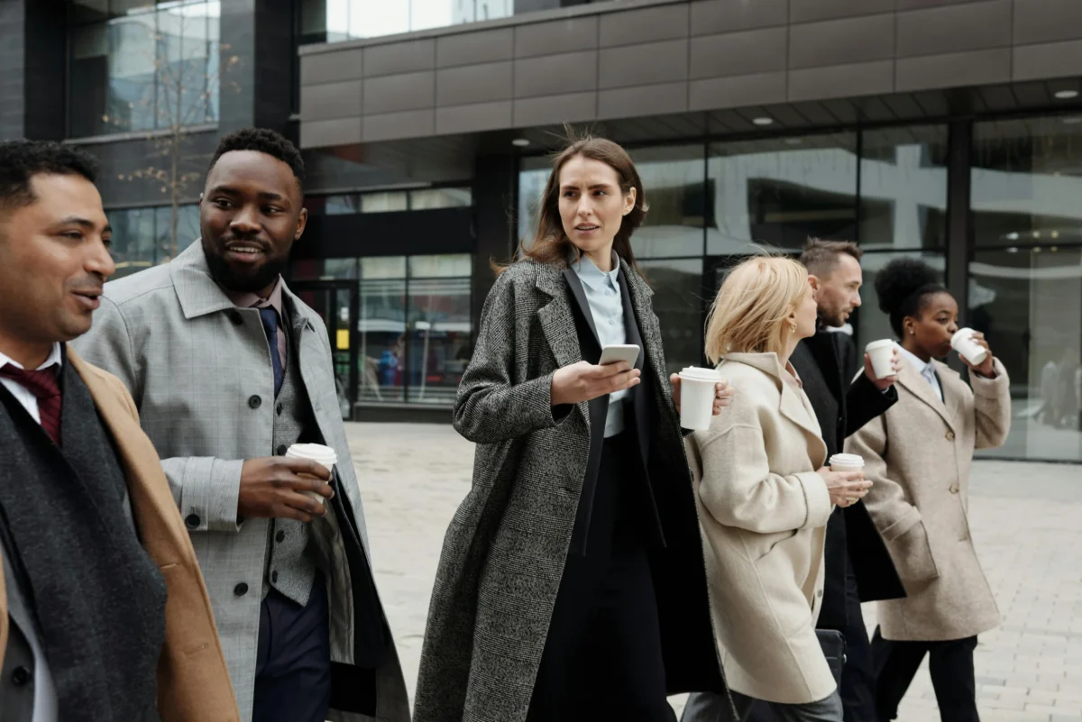 Colleagues walking with coffees on a break.