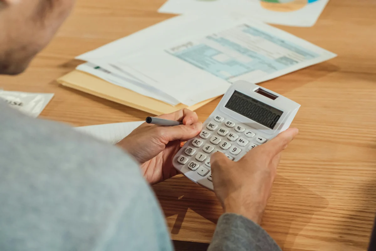 A man uses a calculator to do accounting.