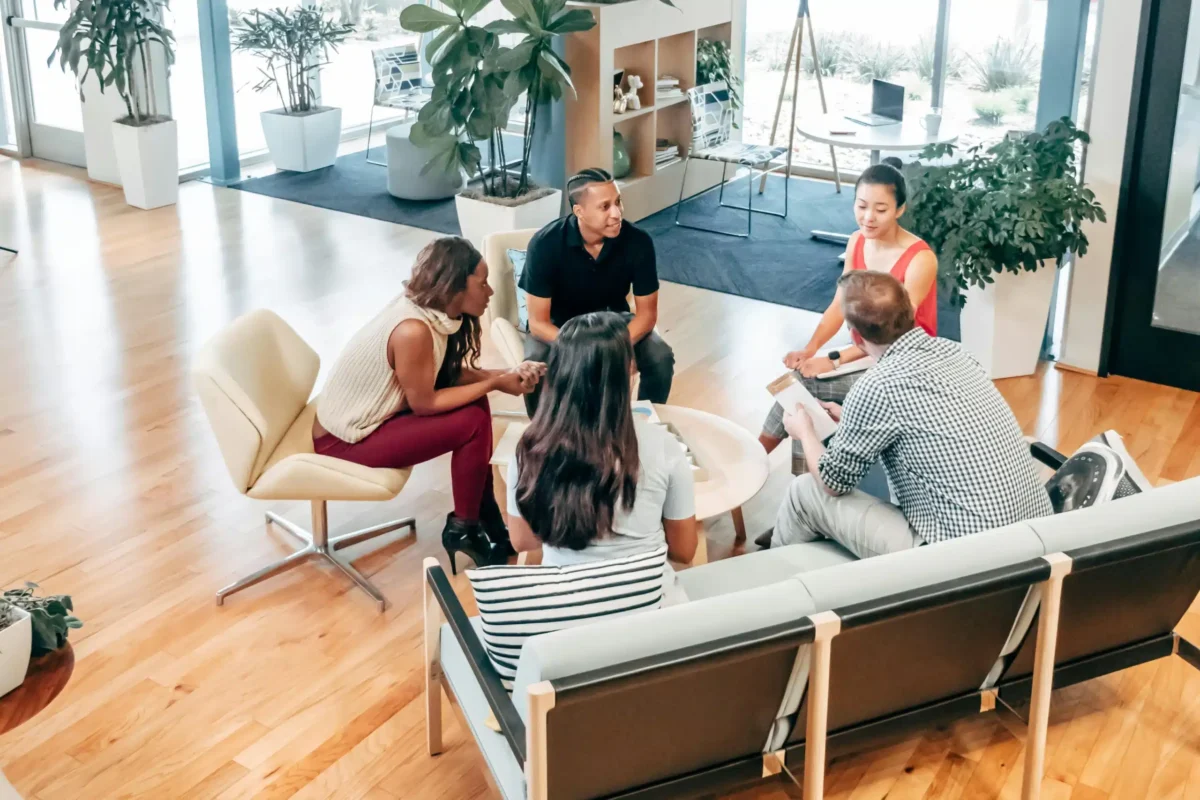 People meeting in the middle of an office.