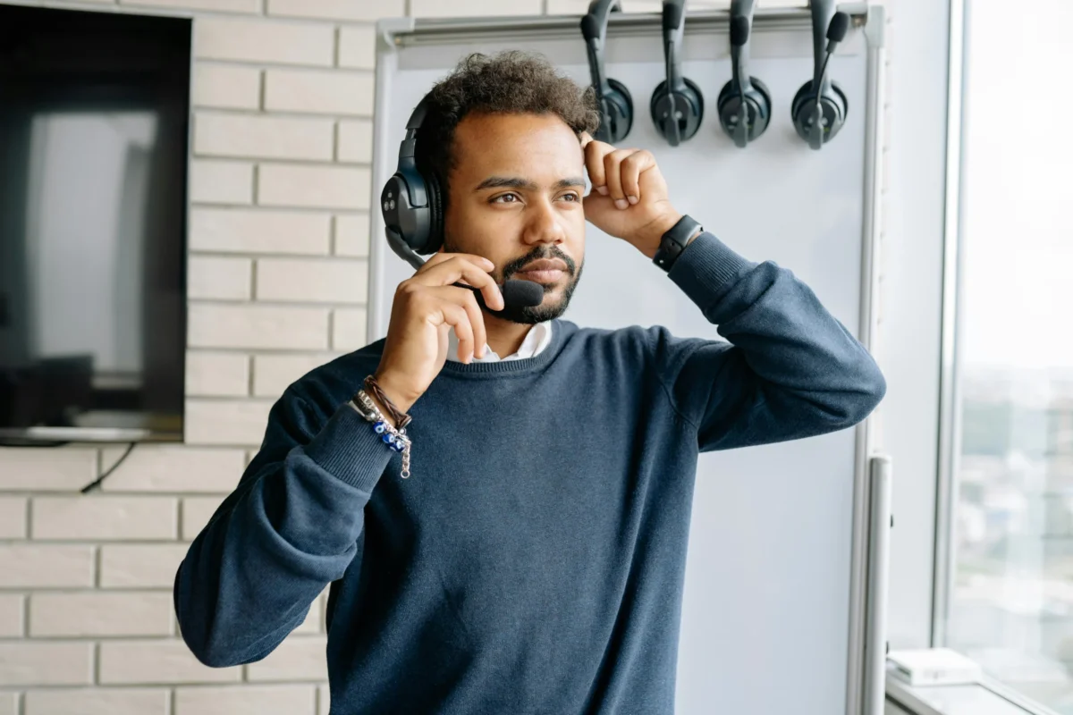 A man uses a headset for a phone call.