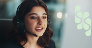 Close up of a smiling intake coordinator on a call with a client.