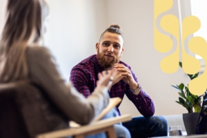 Happy client speaking with his counsellor.