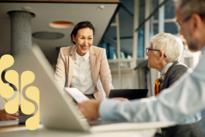 A smiling leader briefing her team.