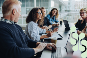 A group of business professionals having a meeting in a bright boardroom.