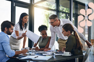 A group of employees reviewing a document together during a brainstorming session.
