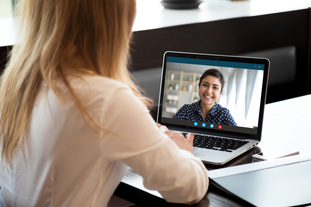 Woman talking to her coaching in a video meeting.